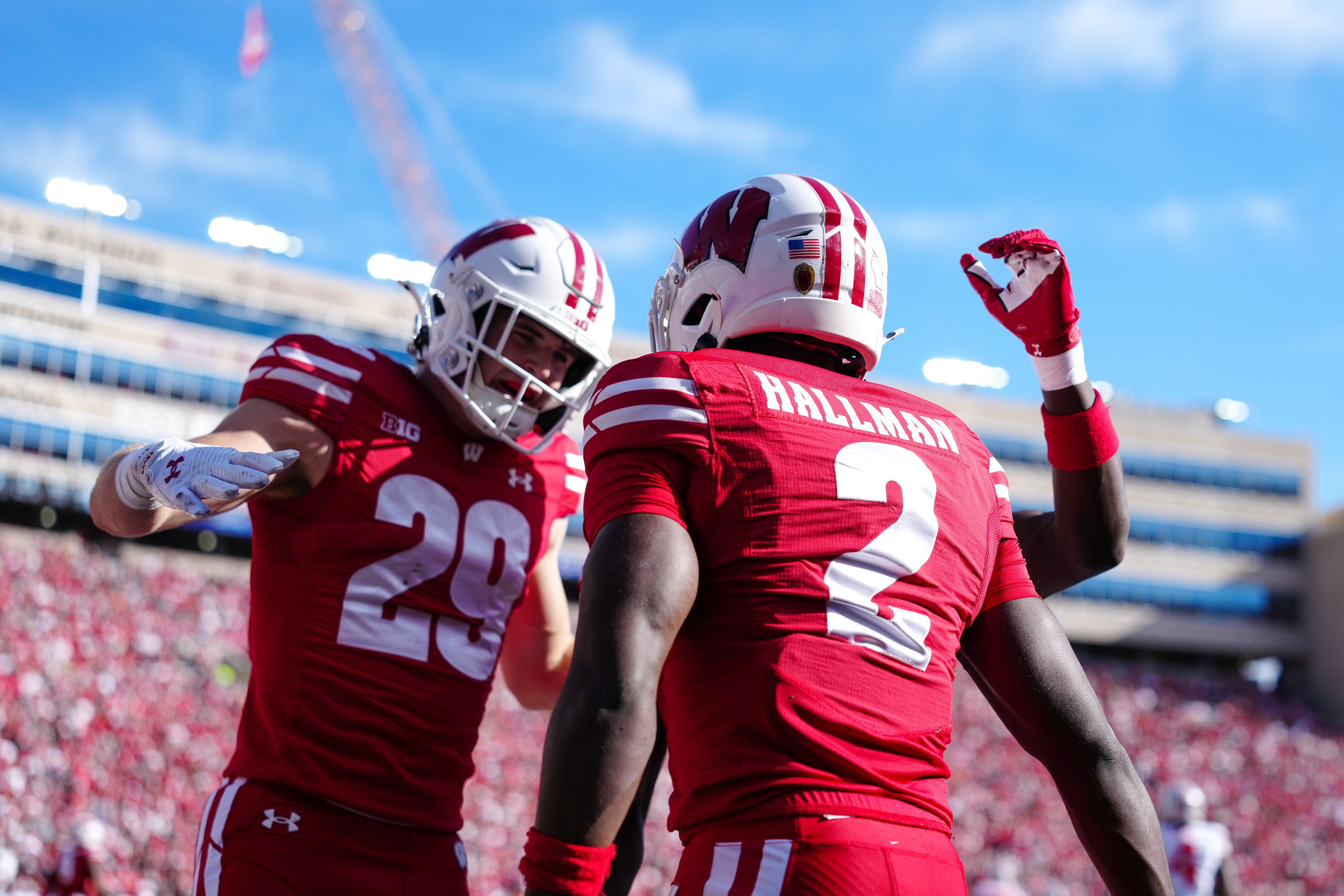 Oct 18, 2025; Madison, Wisconsin, USA; Wisconsin Badgers safety Matthew Jung (29) and cornerback Ricardo Hallman (2) celebrate after deflecting a pass in the end zone in the first half against the Ohio State Buckeyes at Camp Randall Stadium on October 18, 2025 in Madison, Wisconsin. Photography by Ross Harried for Second Crop Sports.